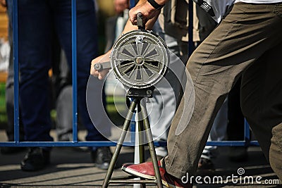 Shallow depth of field image with a man handling a vintage hand crank air raid siren Stock Photo