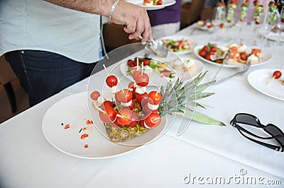 Shallow depth of field selective focus image with a man taking aperitifs from an open buffet table Stock Photo