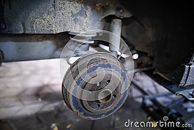 Shallow depth of field selective focus image with a rusty rear wheel hub of an old car Stock Photo