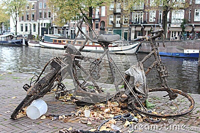 Shallow focus closeup shot of a rusty bicycle near the canal in Amsterdam, the Netherlands Stock Photo