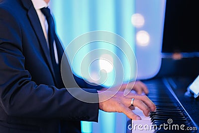 Shallow focus shot of a male pianist playing on a luxury event Stock Photo