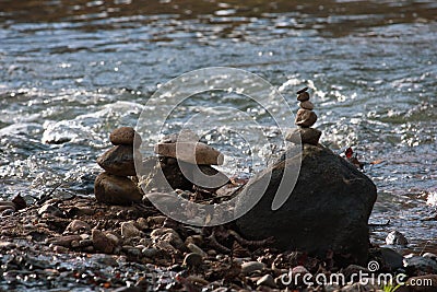 Shallow focus shot of a stack of balancing rocks in the water - zen concept Stock Photo