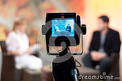 Shallow focus of a Video camera viewfinder, recording show in a TV studio during a talk show Stock Photo