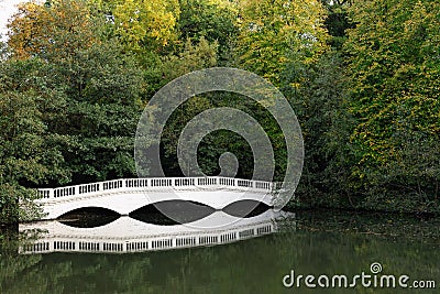 Sham white wooden bridge by lake Stock Photo
