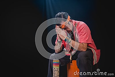 Shaman man, sorcerer, giving thanks duringPre-Hispanic ritual in Healing and cleaning with medicinal plants in Mexico, with black Stock Photo