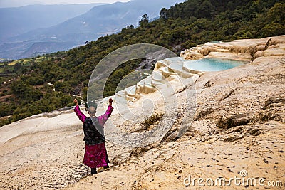 Shaman summoning spirits at the mineral terraces in Baishutai, China. The magic, incantation, occultism. Editorial Stock Photo