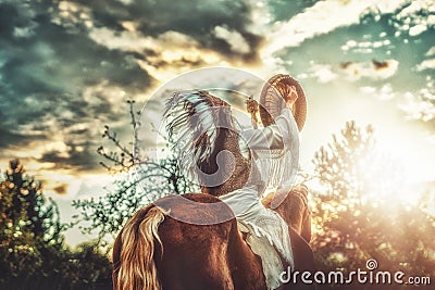 Shaman woman in landscape with her horse. Stock Photo