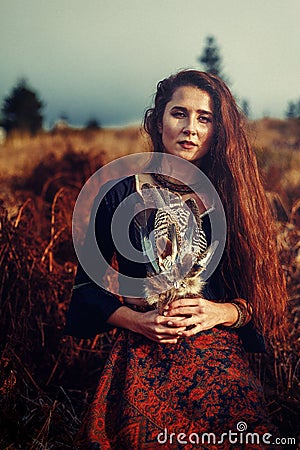 Shaman woman and shamanic feathers on denim. Stock Photo