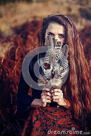 Shaman woman and shamanic feathers on denim. Stock Photo