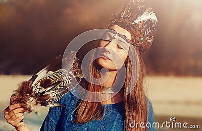 Shaman woman and shamanic feathers on denim. Stock Photo