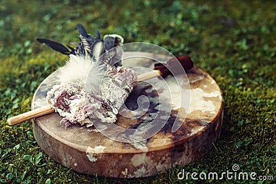 Shamanic drum and shamanic feathers on denim Stock Photo