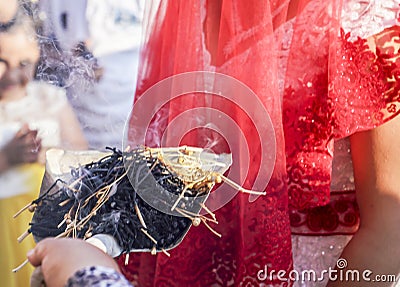 Shamanic tradition for good luck in rural Turkey. Incense of herb sticks smokes goes to young couples in a wedding ceremony Stock Photo