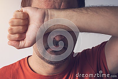 Shame and guilt, man covering face Stock Photo