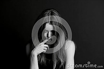 Shame, shyness or . Girl hiding face with hair Stock Photo