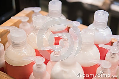 Shampoo body lothion and cream plastic botles in the row for sale in store Stock Photo