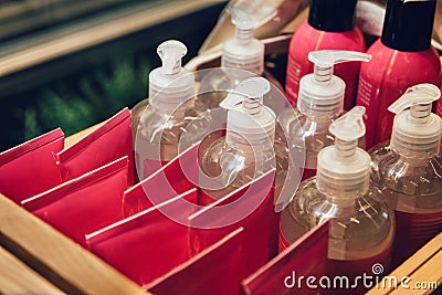 Shampoo body lotion and hand cream plastic bottles in the row for sale in healthcare and beauty store. Stock Photo