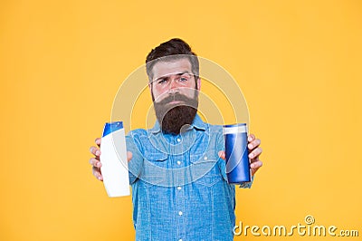 Shampoo conditioner. ombine two products for best results. Liquid soap. Bath cosmetics. Man bearded hipster hold shampoo Stock Photo