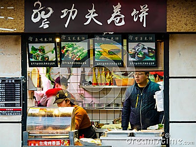 SHANGHAI, CHINA - 12 MAR 2019 - A small Chinese takeaway store in Shanghai serving hot pancakes, flatbread and grilled Taiwan Editorial Stock Photo