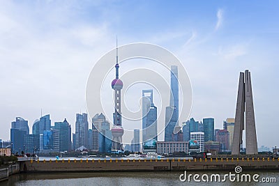 Shanghai high rises office and towers of the Business district skyline at mist behind a pollution haze, across Huangpu river, Editorial Stock Photo