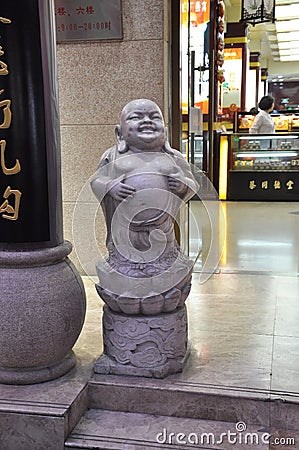 Shanghai, 2nd may: Buddha sculpture front of a Shopping Center entrance from Nanjing pedestrian Road in Shanghai Editorial Stock Photo