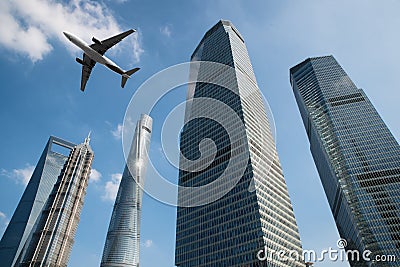 Shanghai skyscrapers buildings and a plane flying overhead at in Stock Photo