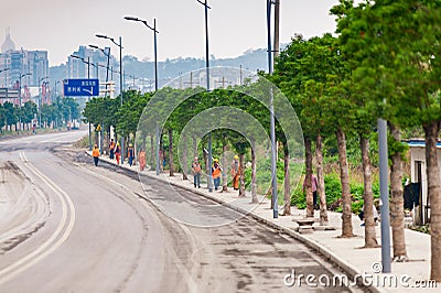 Road with workers walking on a constuction site Editorial Stock Photo