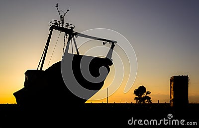 Shape of a boat on the ground in a beautiful sunset Stock Photo