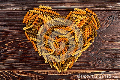 Shape of heart from coloful fusilli pasta. Stock Photo