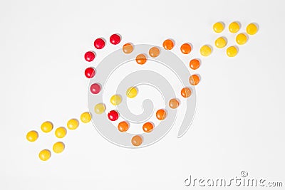 Shape of heart pierced with arrow - symbol of love - made from colorful sweet candies Stock Photo