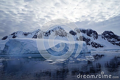 The shape of the iceberg is reflected in the sea. Stock Photo