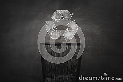 Shape of the symbol of recycling on chalkboard. Protection nature and future concept. Stock Photo