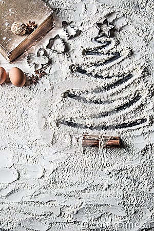 Shaped christmas tree of flour and old recipe book. Stock Photo