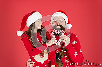 Share joy and happiness. Christmas Carol. Father and daughter with candy canes christmas decorations. Family holiday Stock Photo