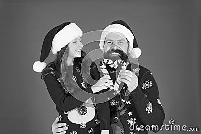 Share joy and happiness. Christmas Carol. Father and daughter with candy canes christmas decorations. Family holiday Stock Photo