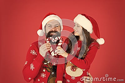 Share joy and happiness. Christmas Carol. Father and daughter with candy canes christmas decorations. Family holiday Stock Photo