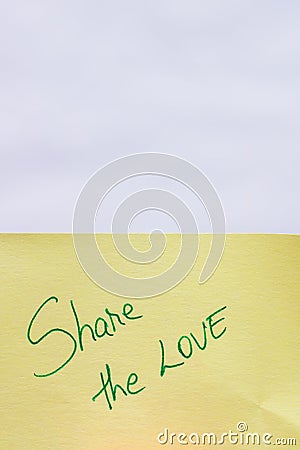 Share the love handwriting text close up isolated on yellow paper with copy space Stock Photo
