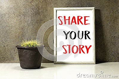 Share your story concept in ornate picture frame photo and Genus Echinocactus Cactus a potted plant on marble table Stock Photo