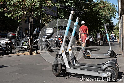 Shared Electric Kick Scooter or e-steps in a street in Rome Editorial Stock Photo