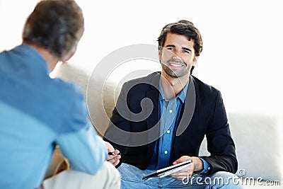 Sharing great financial advice. A young consultant giving a mature client some advice. Stock Photo