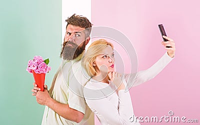 Sharing happy selfie. Woman capturing happy moment boyfriend bring bouquet flowers. Capturing moment to memorize. Taking Stock Photo