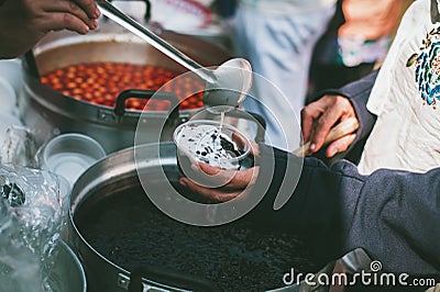 Sharing warm food for homeless and homeless people Stock Photo