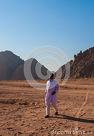 SHARM EL SHEIKH, EGYPT - JULY 9, 2009. Bedouin walking on desert Editorial Stock Photo