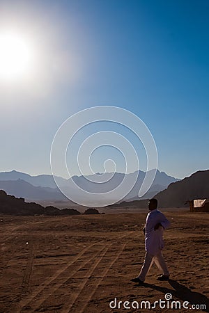 SHARM EL SHEIKH, EGYPT - JULY 9, 2009. Bedouin walking on desert Editorial Stock Photo