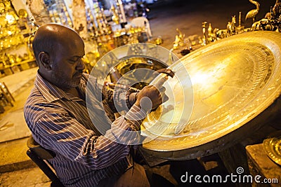 Man making the bronze tray at night Editorial Stock Photo