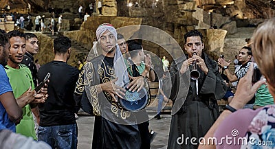 Two young Egyptian playing folk instruments on town square in evening. Editorial Stock Photo