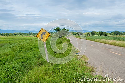 Sharp curve on rice field Stock Photo