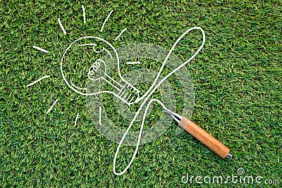 Sharp pencil and bulb drawing on green grass background Stock Photo
