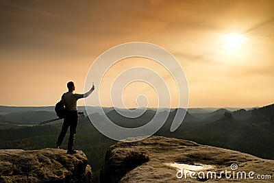 Sharp silhouette of active man on mountain peak Stock Photo