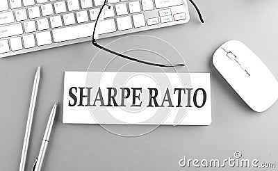 SHARPE RATIO text on paper with keyboard on grey background Stock Photo