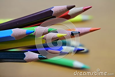 Sharpened color pencil on brown wood background Stock Photo